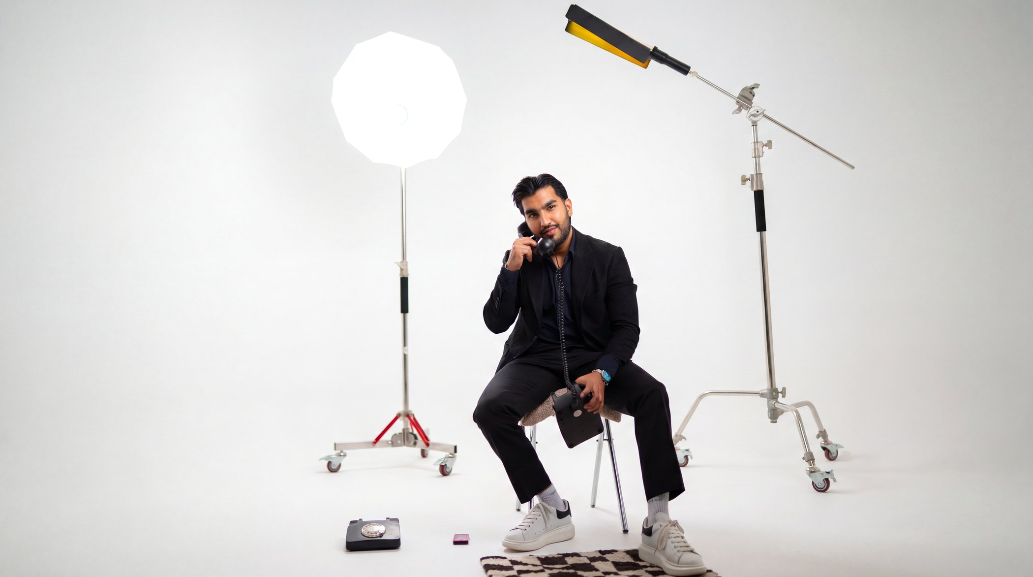 Sultan Bhatti, marketing leader and brand builder, seated in a bright photography studio in Dubai